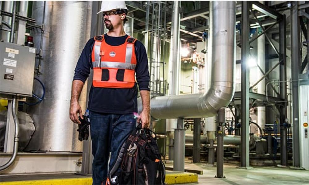 HVAC worker with orange phase change vest