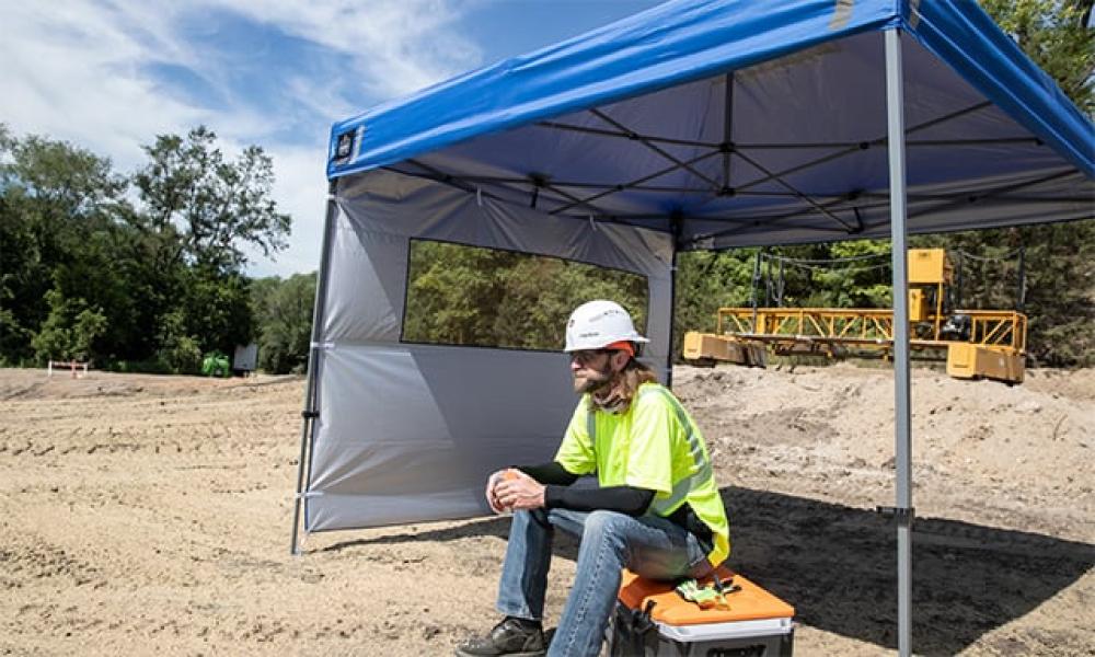 Worker under shelter getting shade