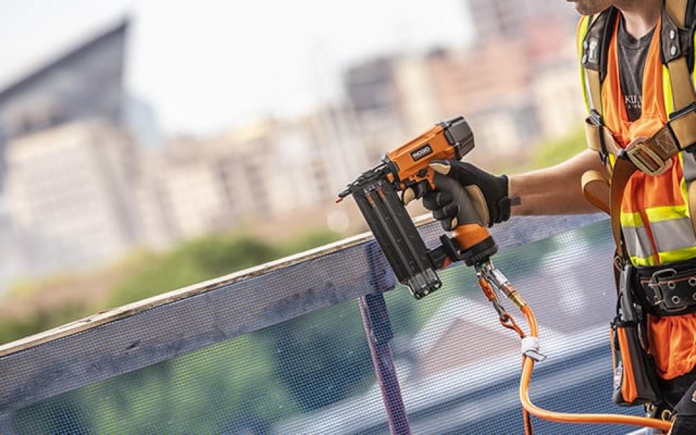 Tethered nail gun with city in the background