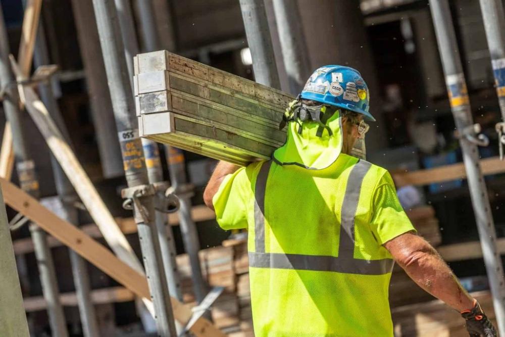 Worker in the sun, protecting their neck with an attached neck shade