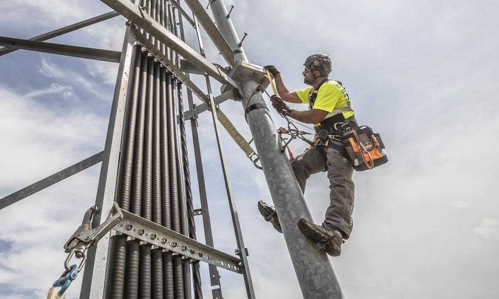 Worker climbing tower