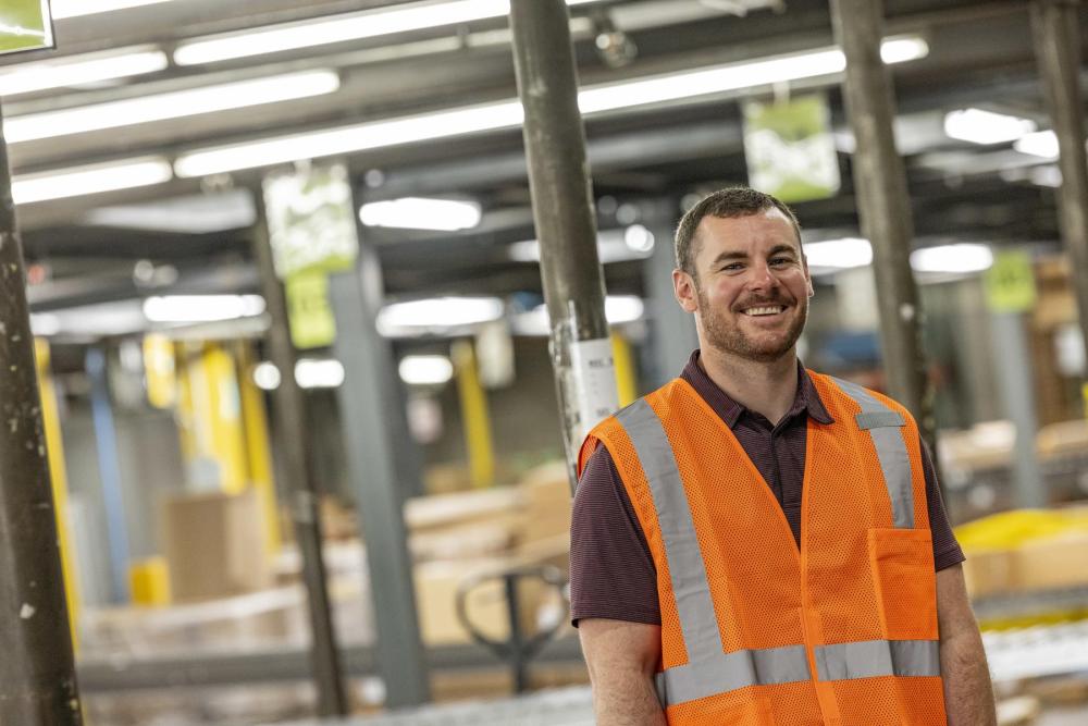 man wearing hi-vis vest in warehouse