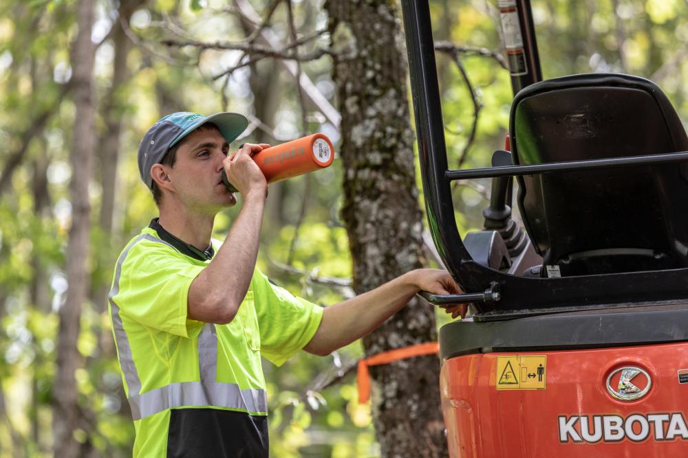 man drinking from a water bottle