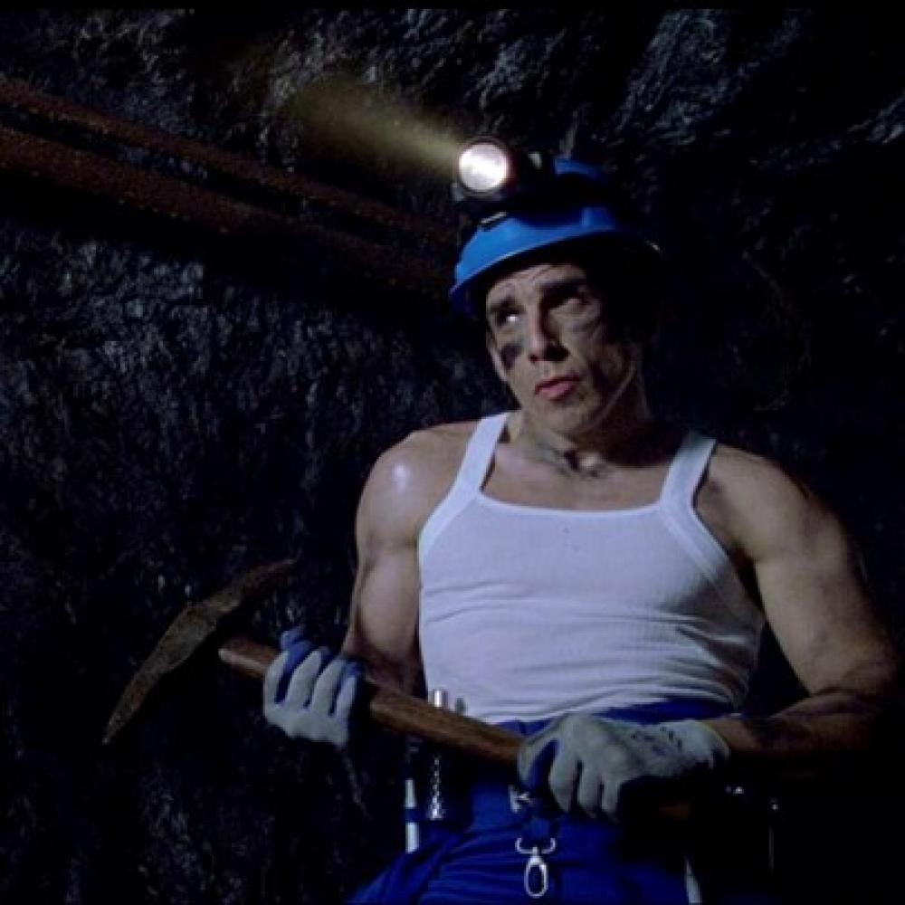 Worker in a mine wearing a pickaxe