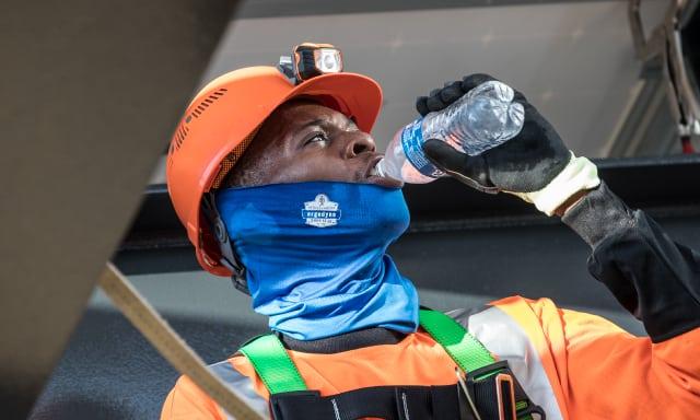 Worker working in the heat drinking water