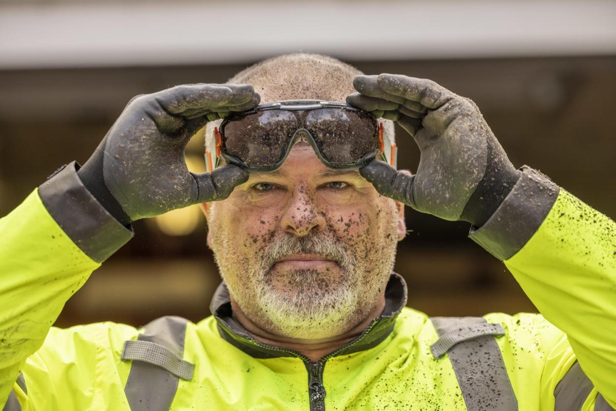 man wearing safety goggles with dirt on face