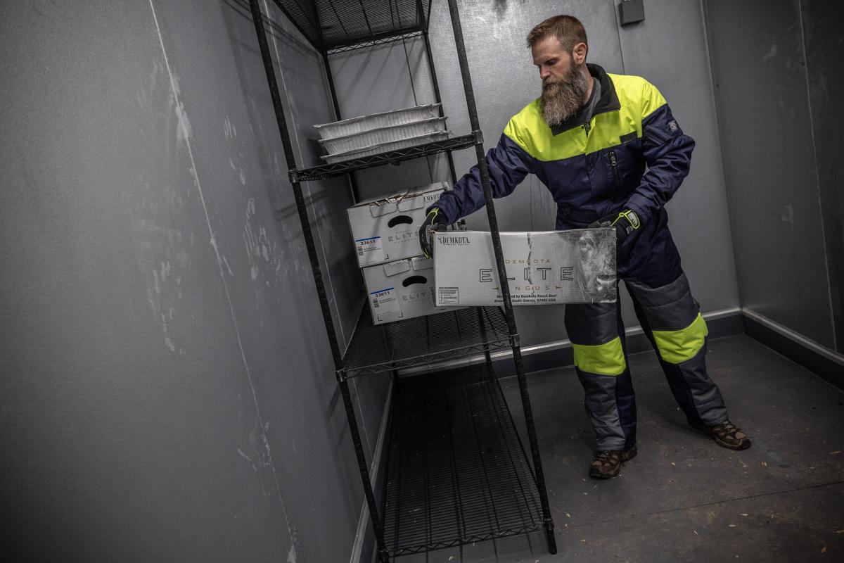 Man wearing Cold Storage gear in a chiller room