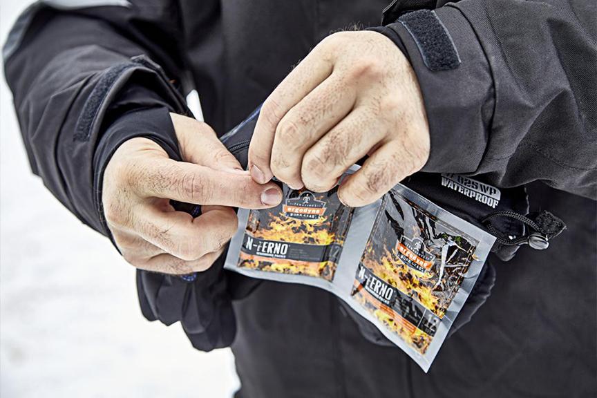 Person opening hand warming packs.
