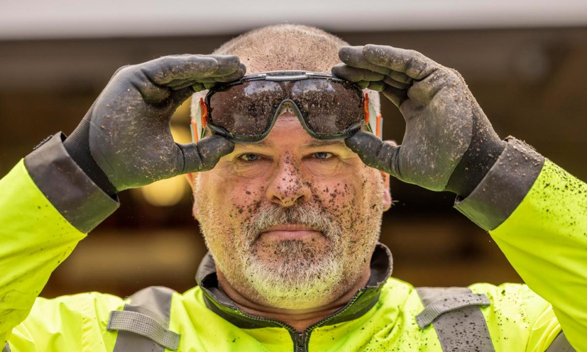 man wearing safety goggles with dirt on face