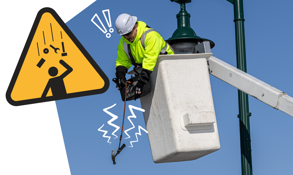 Workering dropping a tethered hammer in a bucket truck