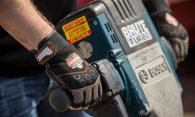 worker operating a jackhammer wearing anti-vibration gloves