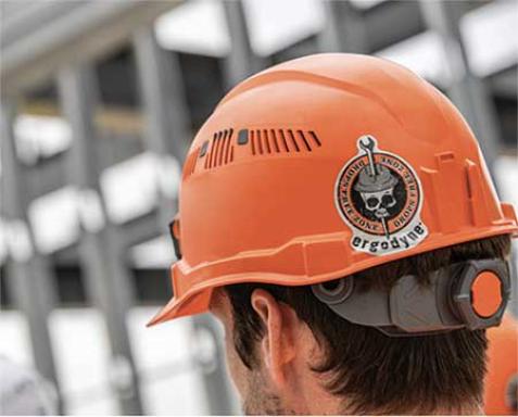 Orange hard hat on head with Ergodyne sticker