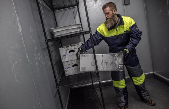 Cold storage worker moving boxes